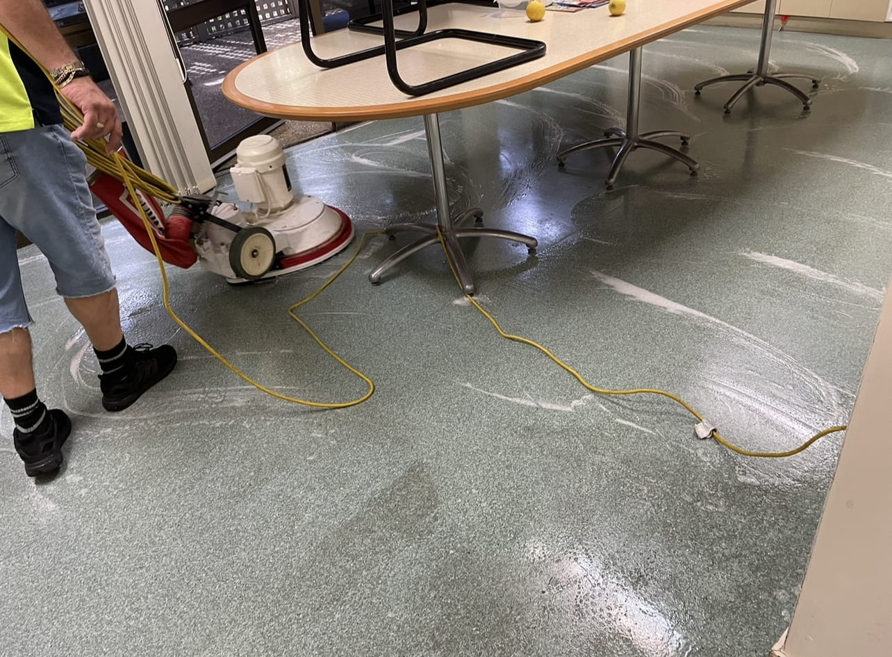 A Cheetah Maintenance cleaner running a rotary buffer across a commercial floor